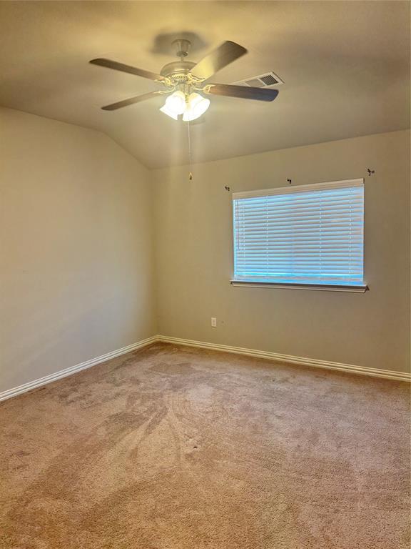 4475 Samarth Street Irving, TX 75061 - Photo 14 of 26 an empty room with a chandelier fan and windows