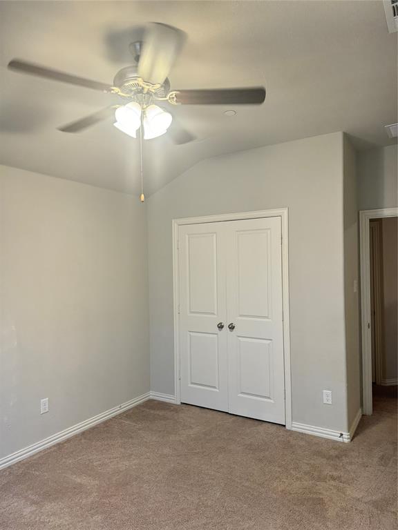 4475 Samarth Street Irving, TX 75061 - Photo 18 of 26 an empty room with a chandelier fan and closet area