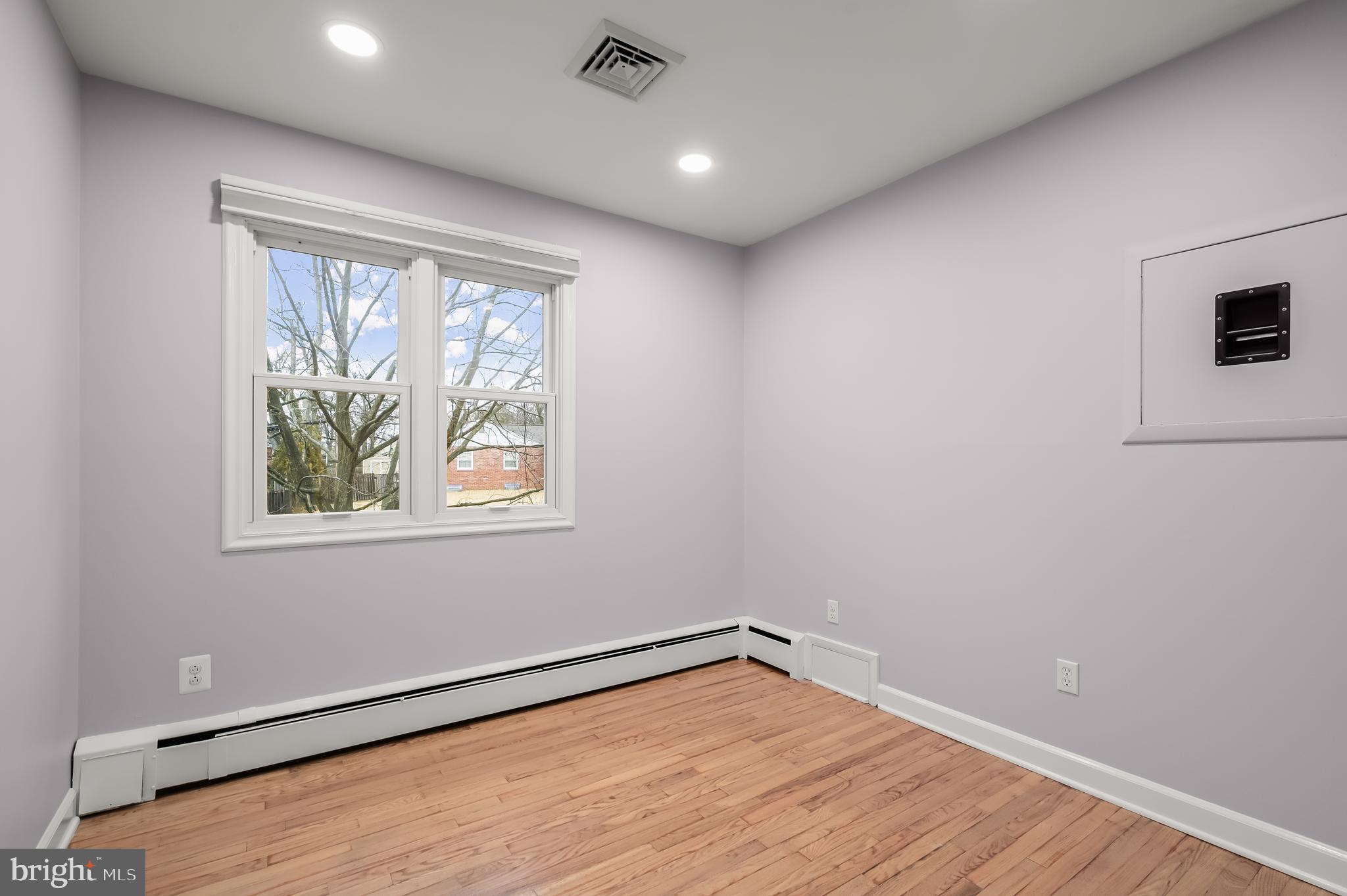 10600 Lilac Place Silver Spring, MD 20903 - Photo 28 of 43 an empty room with wooden floor and windows