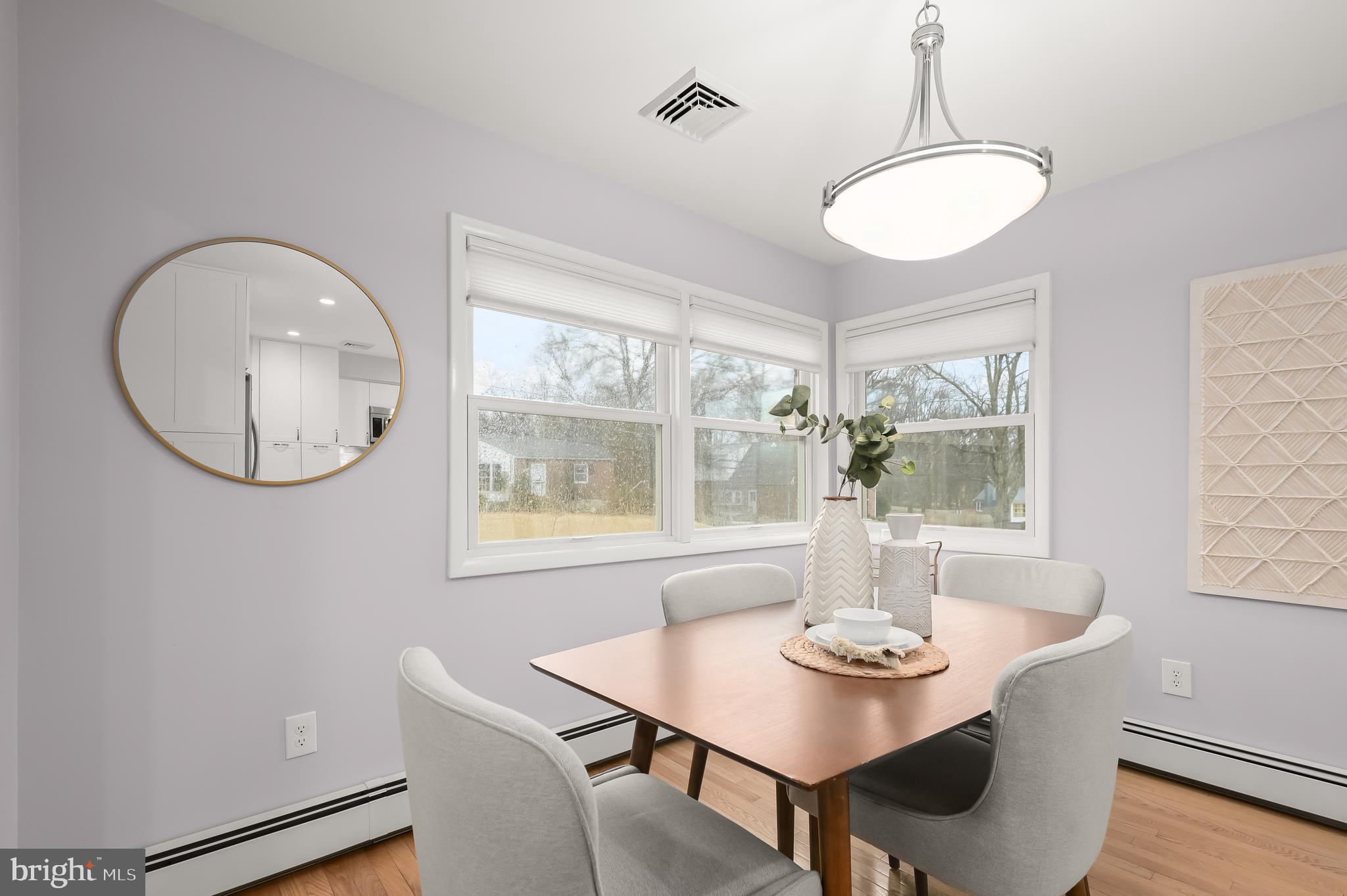 10600 Lilac Place Silver Spring, MD 20903 - Photo 9 of 43 a view of a dining room with furniture window and wooden floor