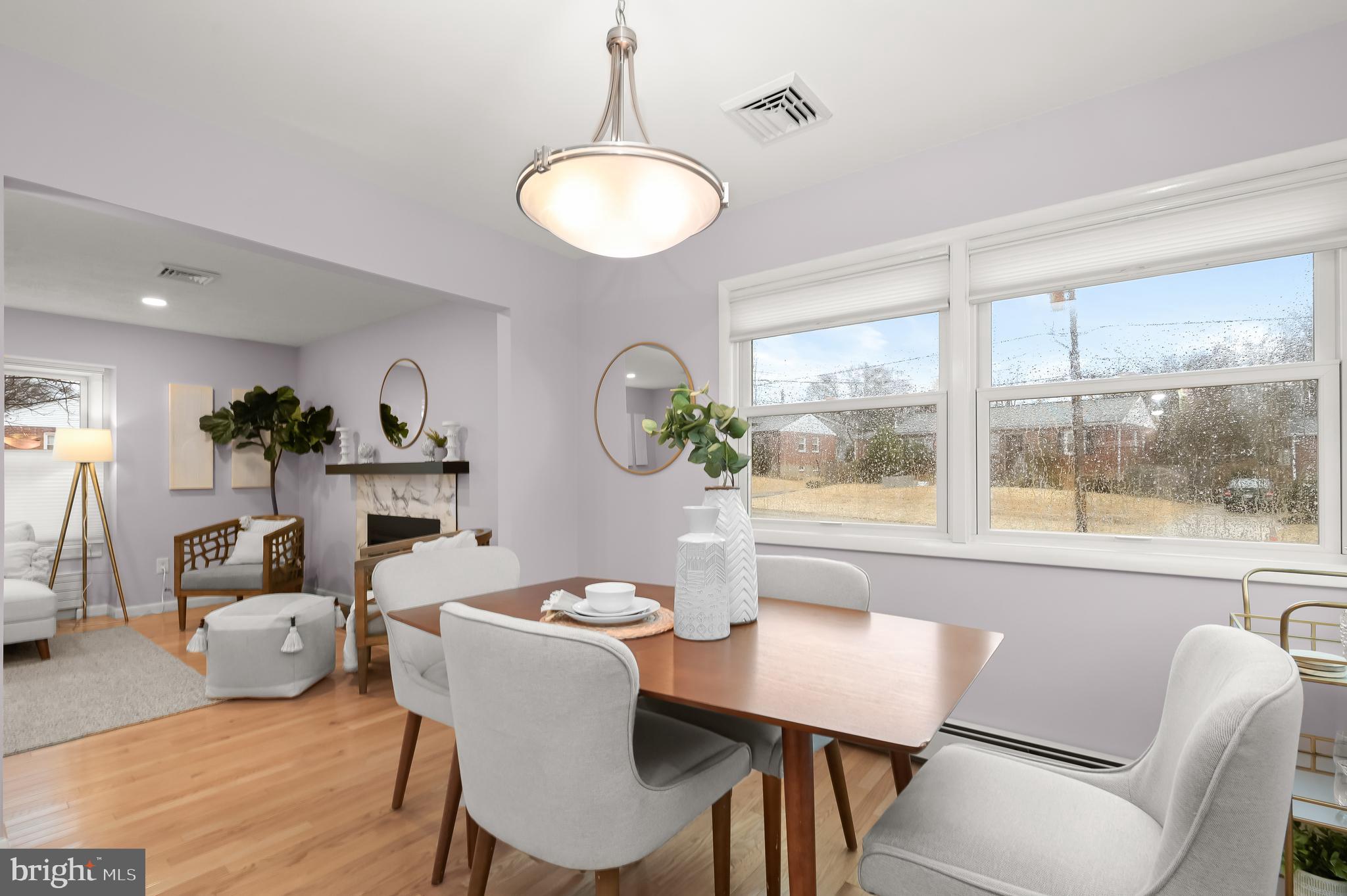 10600 Lilac Place Silver Spring, MD 20903 - Photo 10 of 43 a view of a dining room with furniture wooden floor and a chandelier