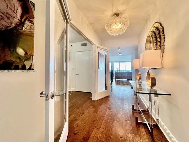 a view of a hallway view with wooden floor and staircase