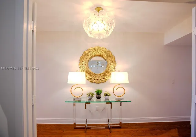 a view of a chandelier fan and wooden floor