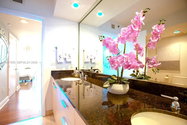 a very nice looking dining room with a large kitchen island and a chandelier