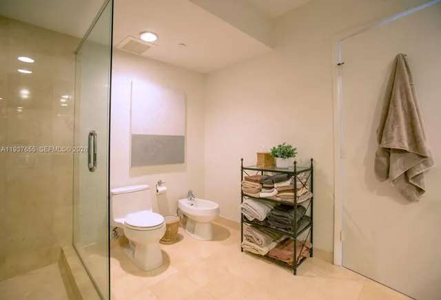a bathroom with a toilet sink and a shower