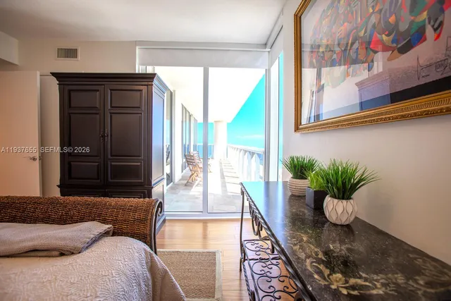 a living room filled with furniture and a potted plant