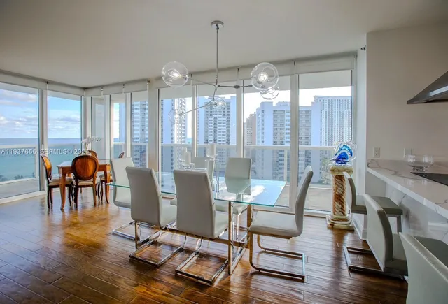 a view of a dining room with furniture window and wooden floor