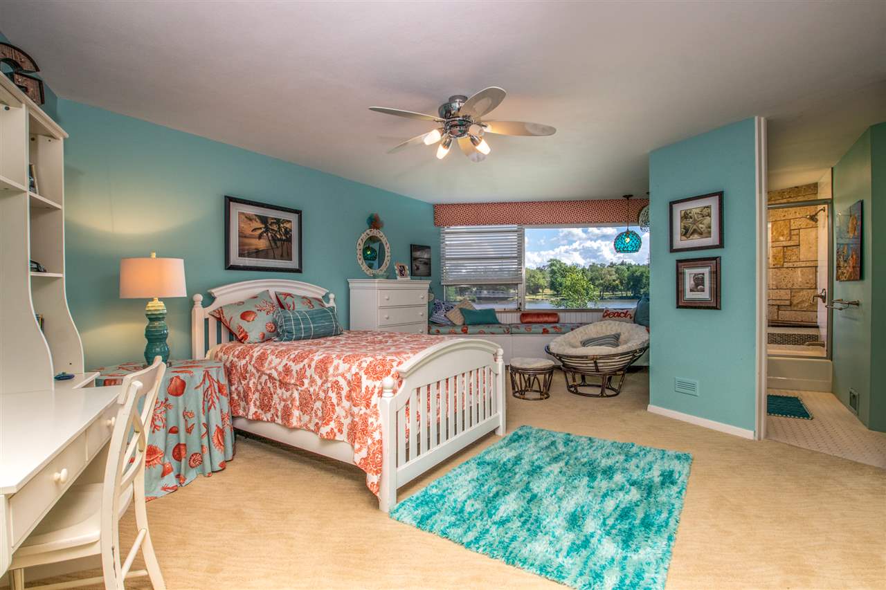 2121 Harlem Boulevard Rockford, IL 61103 - Photo 17 of 25 a bedroom with a bed and a chandelier