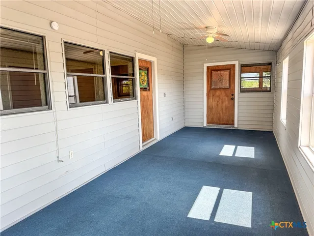 a view of a house with a large tree and a yard