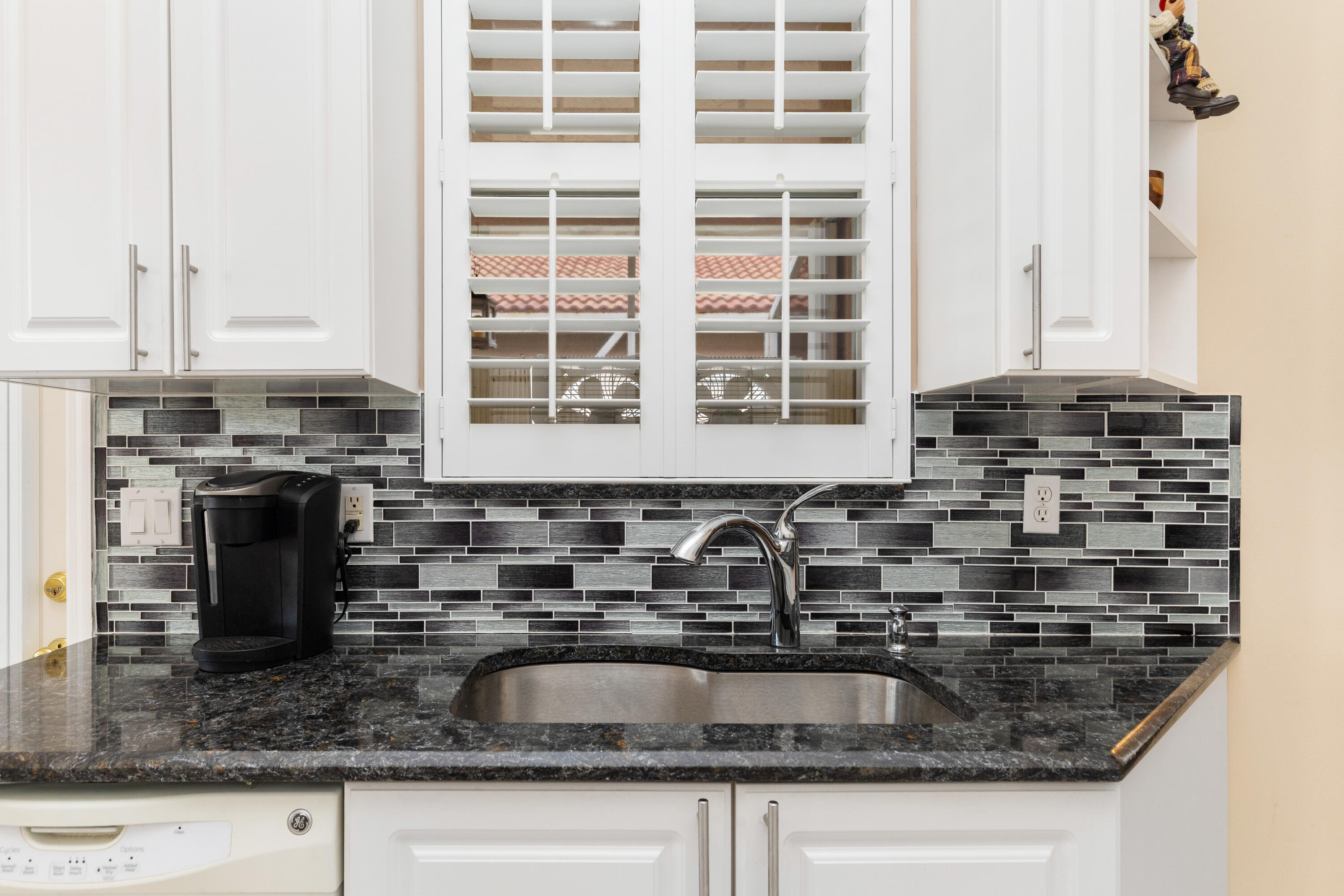 6698 Vía Roma Delray Beach, FL 33446 - Photo 10 of 50 a kitchen with granite countertop a sink and a stove