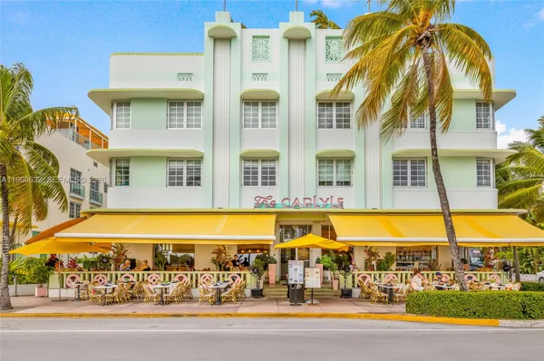 a view of an swimming pool with a lawn chairs under an umbrella