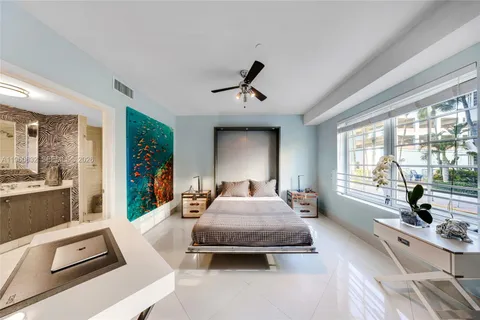 a bedroom with furniture and a window