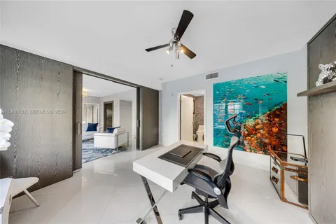 a bedroom with furniture large window and a ceiling fan