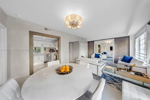 a kitchen with a refrigerator and white cabinets