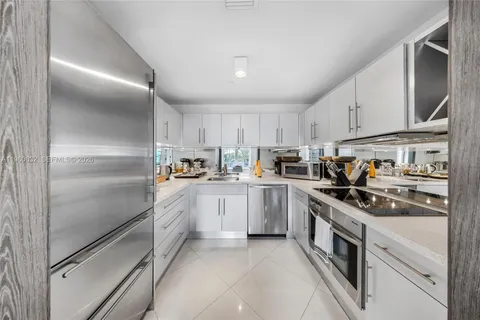 a kitchen with a sink a stove and cabinets