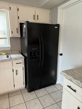 a kitchen with a refrigerator and cabinets