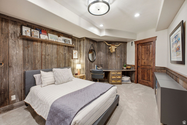 7885 North Rabbitbrush Court, Unit 13 Park City, UT 84098 - Photo 52 of 88 Bedroom featuring a rustic wood-plank accent wall, built-in wooden desk with integrated drawers, and a solid wood paneled door