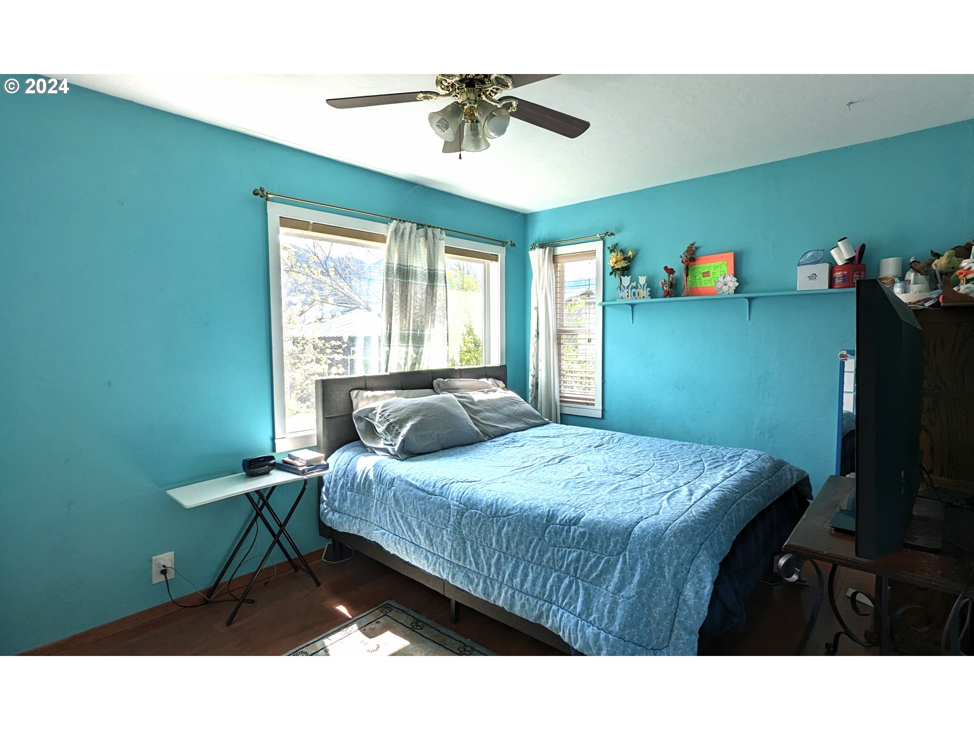 47880 West 2nd Street Oakridge, OR 97463 - Photo 12 of 36 a bedroom with a bed and a chandelier