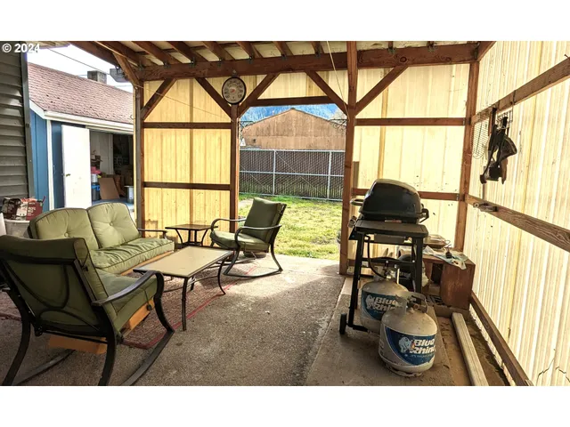 a living room with furniture and a floor to ceiling windows