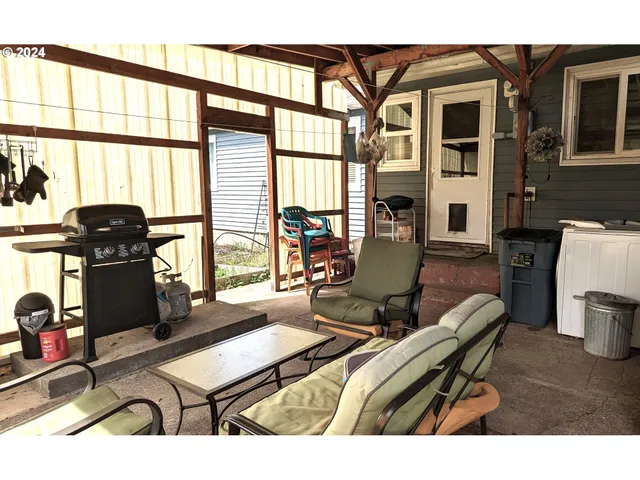 a living room with furniture a fireplace and large windows