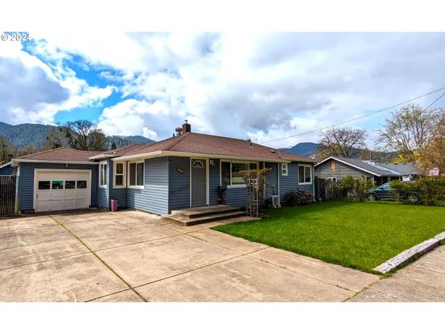 a front view of house with yard and green space