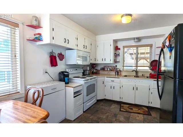 a kitchen with cabinets and window