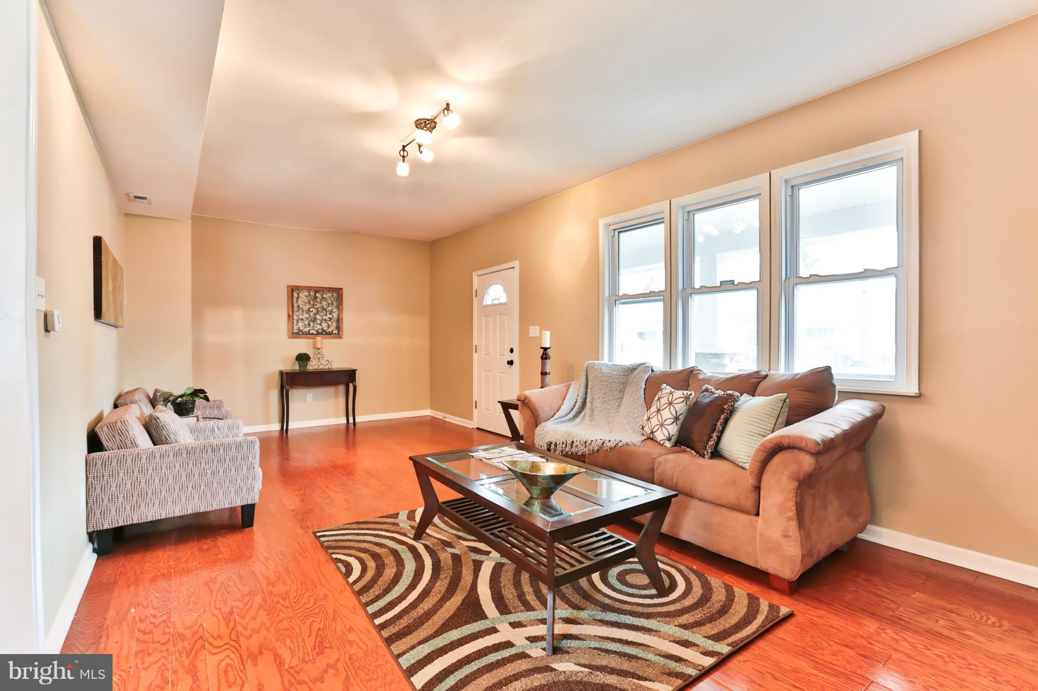 3710 Barrington Road Baltimore, MD 21215 - Photo 3 of 25 a living room with furniture and a chandelier