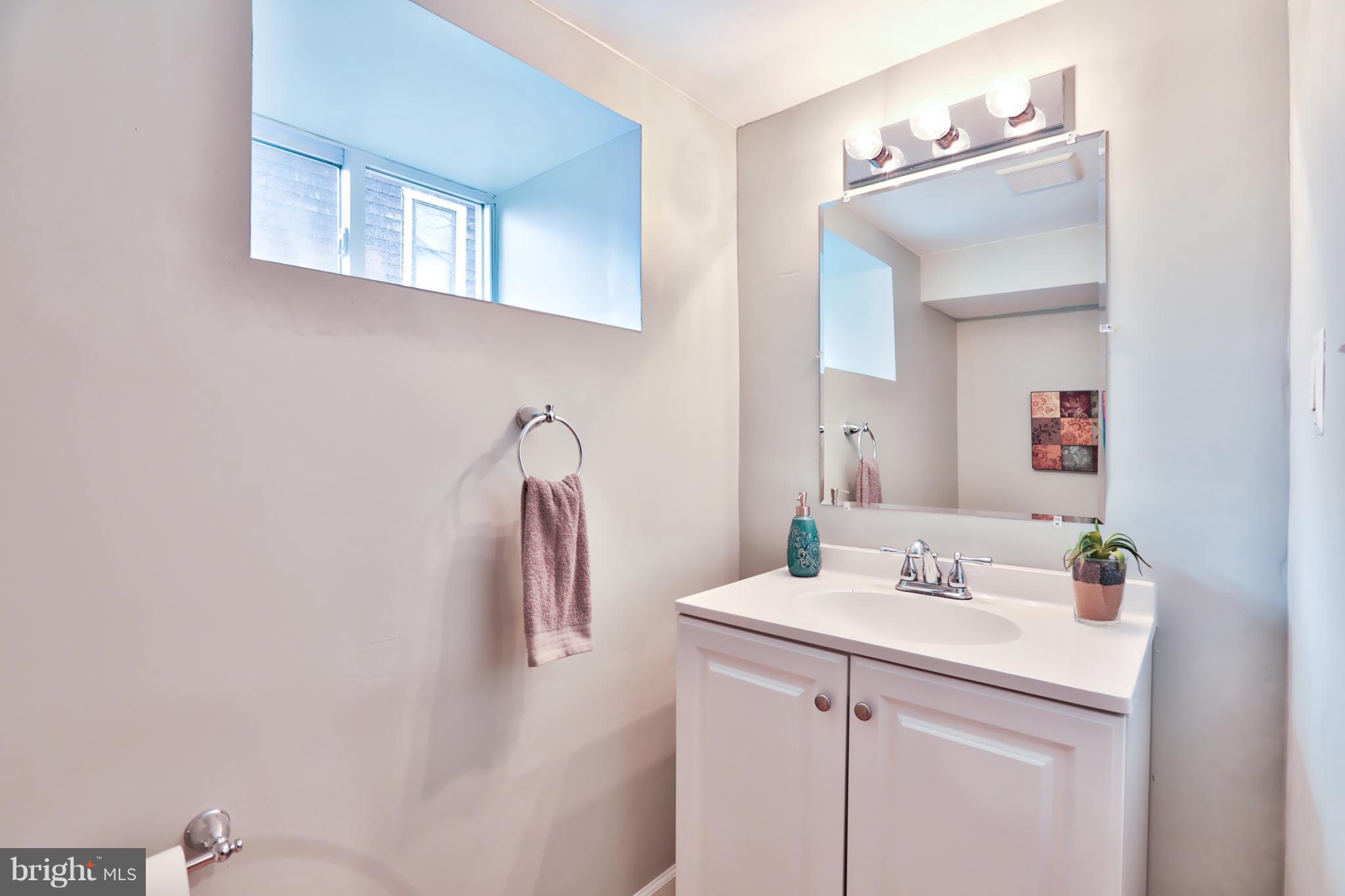 3710 Barrington Road Baltimore, MD 21215 - Photo 22 of 25 a bathroom with a sink and a mirror