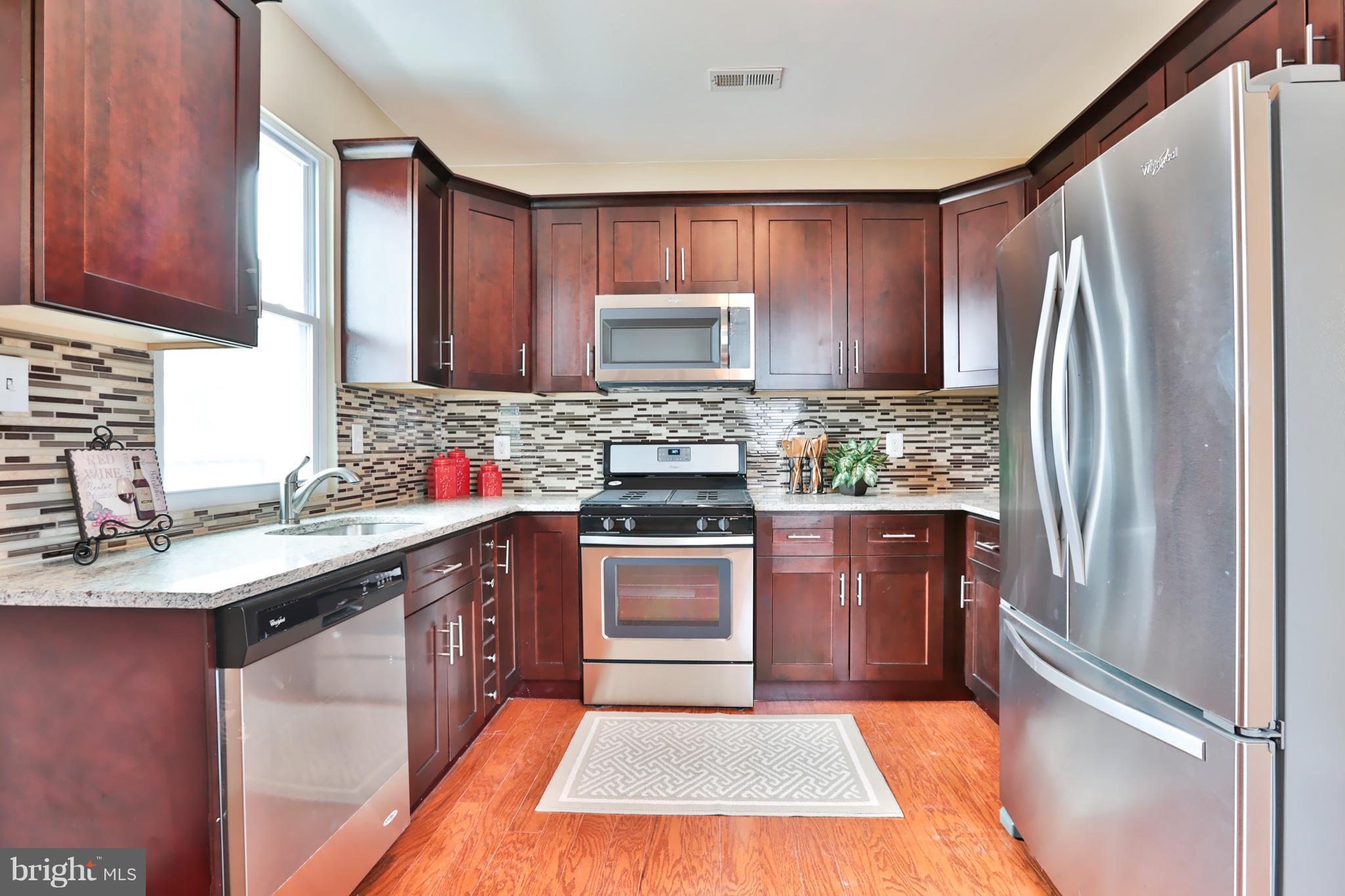 3710 Barrington Road Baltimore, MD 21215 - Photo 8 of 25 a kitchen with stainless steel appliances granite countertop a refrigerator stove and sink