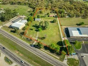 a view of a field with trees in the background