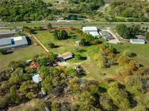 a view of a lake with a yard and large trees
