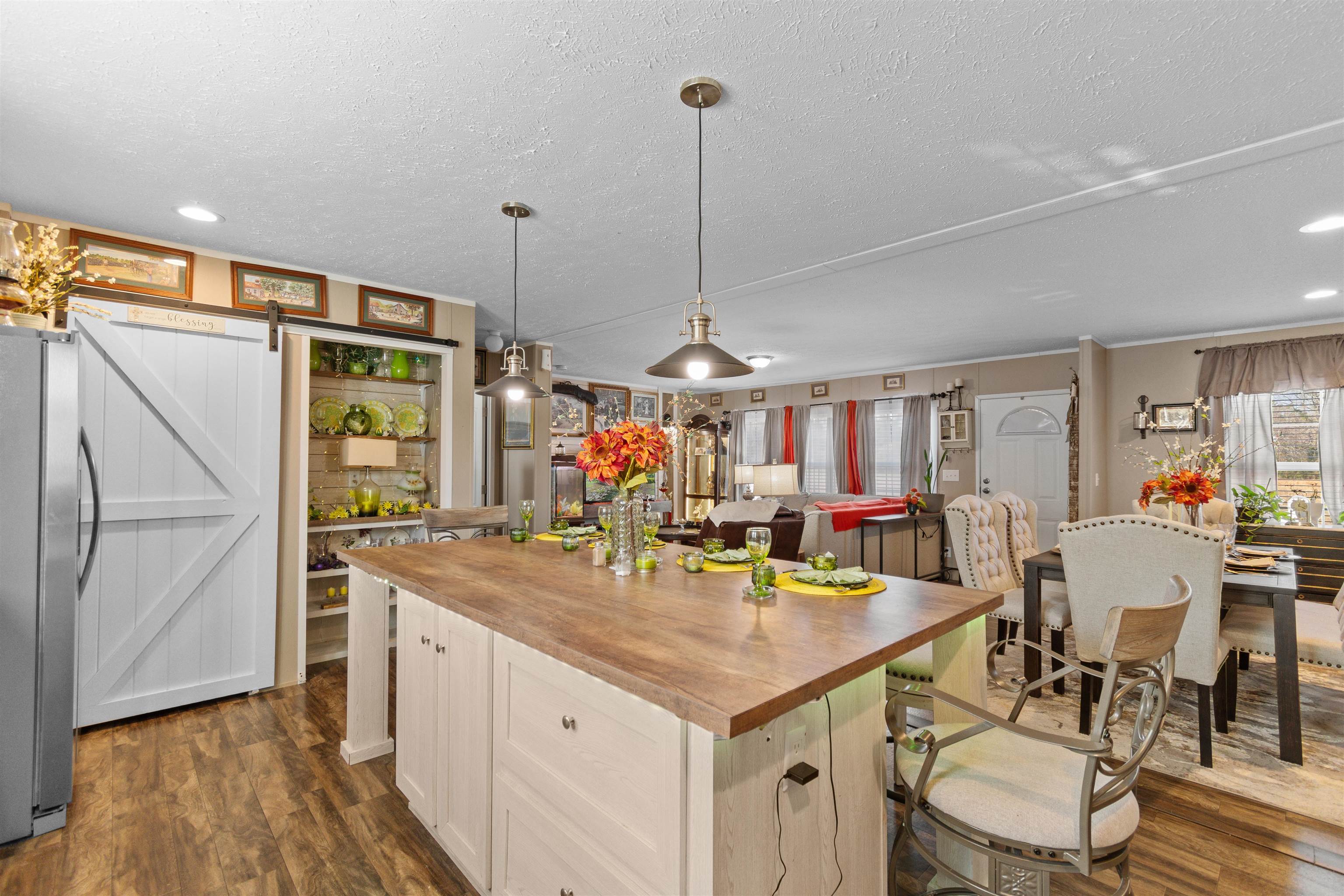 2482 Wigley Road Loris, SC 29569 - Photo 14 of 39 Kitchen featuring a barn door, hanging light fixtures, butcher block counters, appliances with stainless steel finishes, and dark wood finished floors
