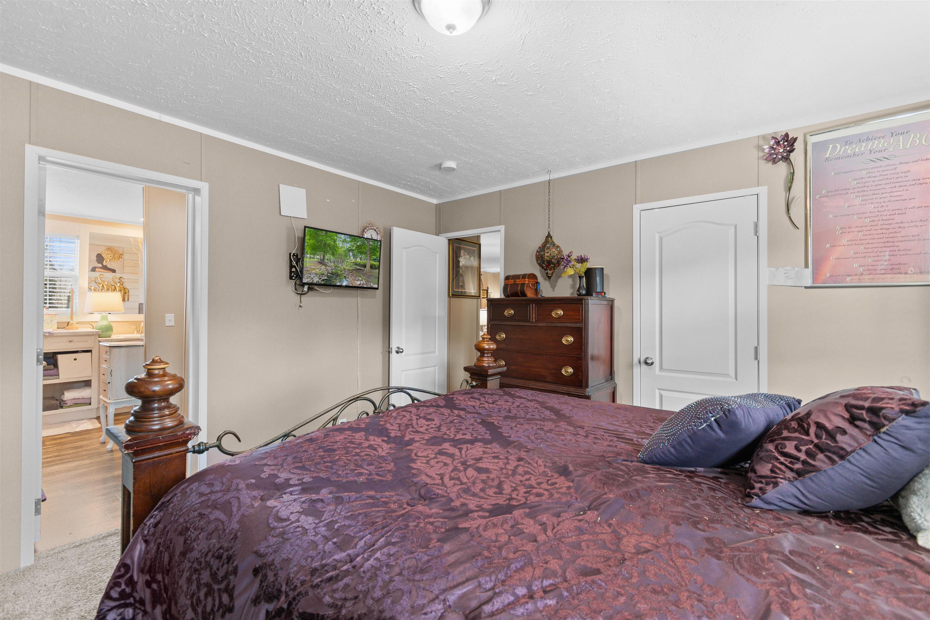 2482 Wigley Road Loris, SC 29569 - Photo 19 of 39 Bedroom with light carpet and a textured ceiling