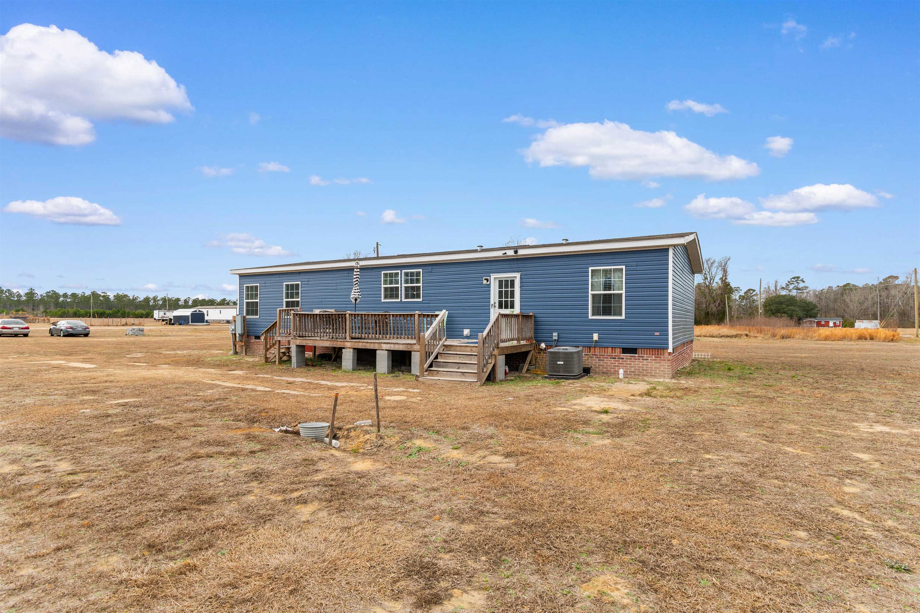 2482 Wigley Road Loris, SC 29569 - Photo 36 of 39 Back of property with crawl space, a wooden deck, and stairway
