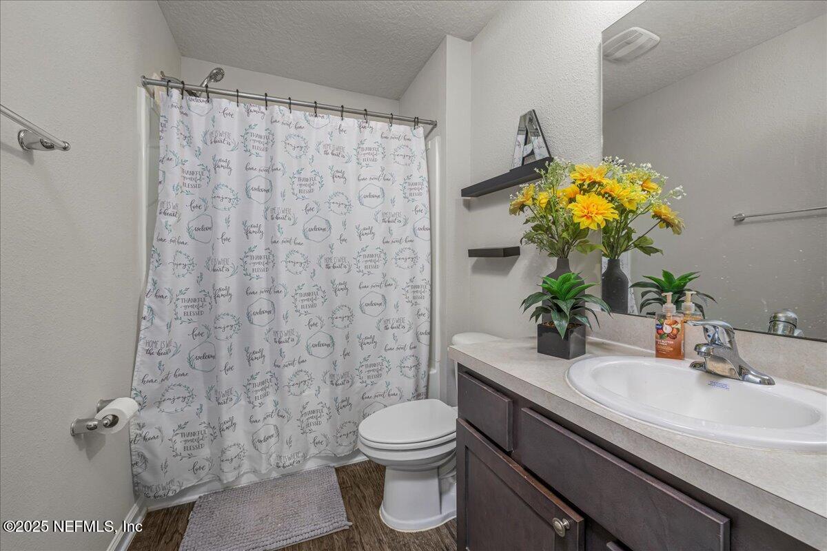 3557 Grayson Lane Middleburg, FL 32068 - Photo 11 of 18 a bathroom with a sink a toilet and a mirror