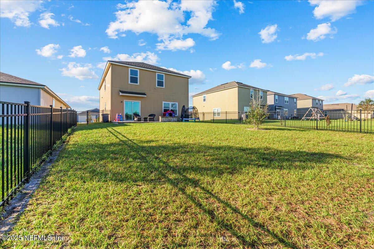 3557 Grayson Lane Middleburg, FL 32068 - Photo 18 of 18 a view of a big house with a big yard and a large tree