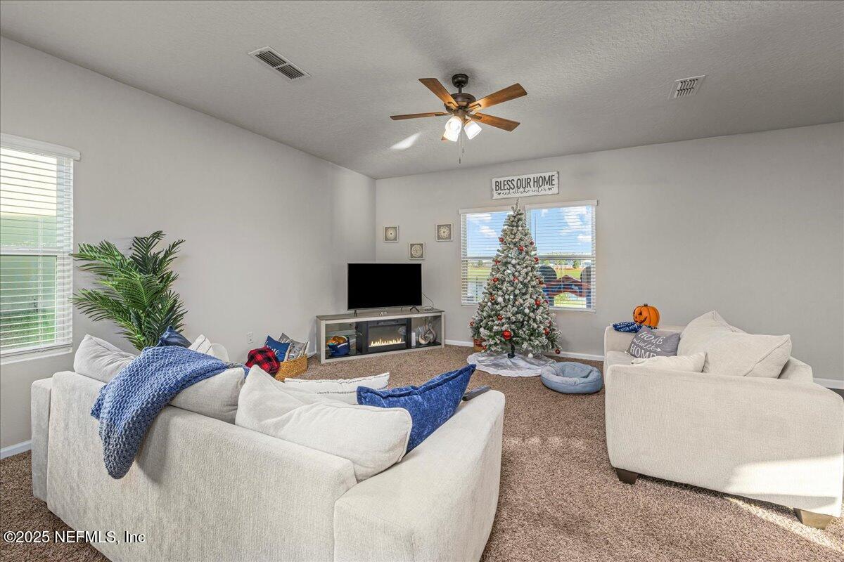 3557 Grayson Lane Middleburg, FL 32068 - Photo 2 of 18 a living room with furniture and a flat screen tv