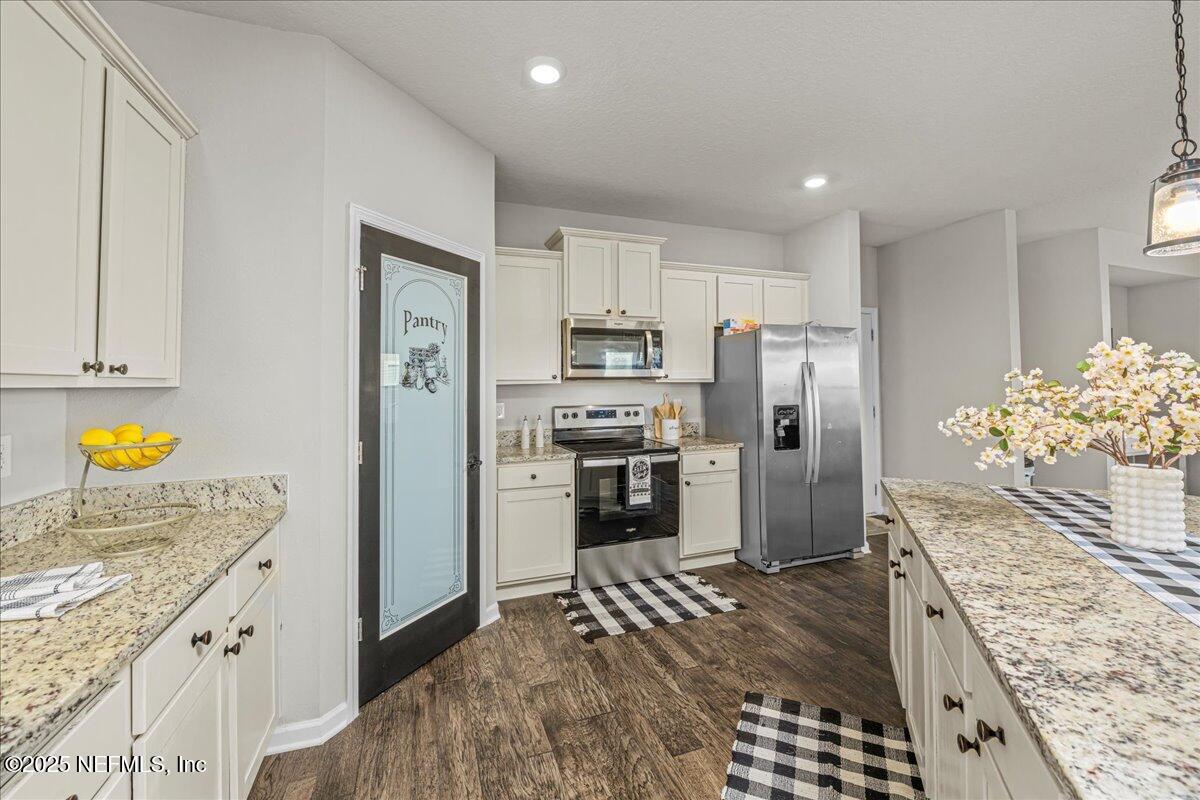 3557 Grayson Lane Middleburg, FL 32068 - Photo 4 of 18 a kitchen with stainless steel appliances granite countertop a refrigerator a stove and a sink