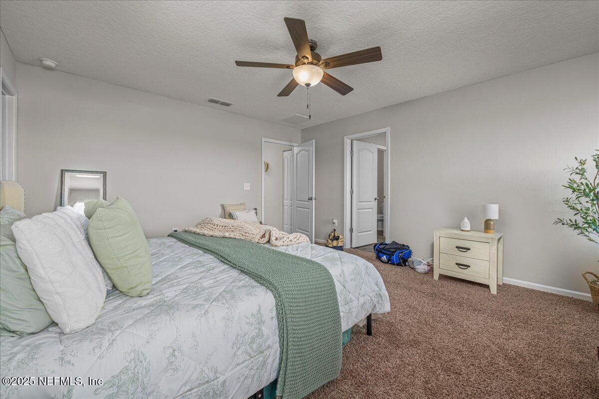 3557 Grayson Lane Middleburg, FL 32068 - Photo 6 of 18 a bedroom with a bed and a chandelier fan