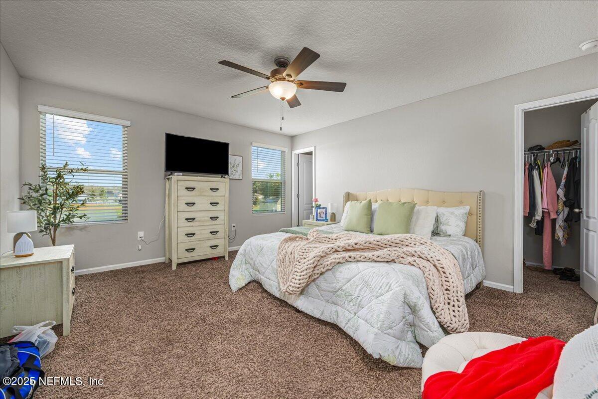 3557 Grayson Lane Middleburg, FL 32068 - Photo 7 of 18 a spacious bedroom with a bed and a television