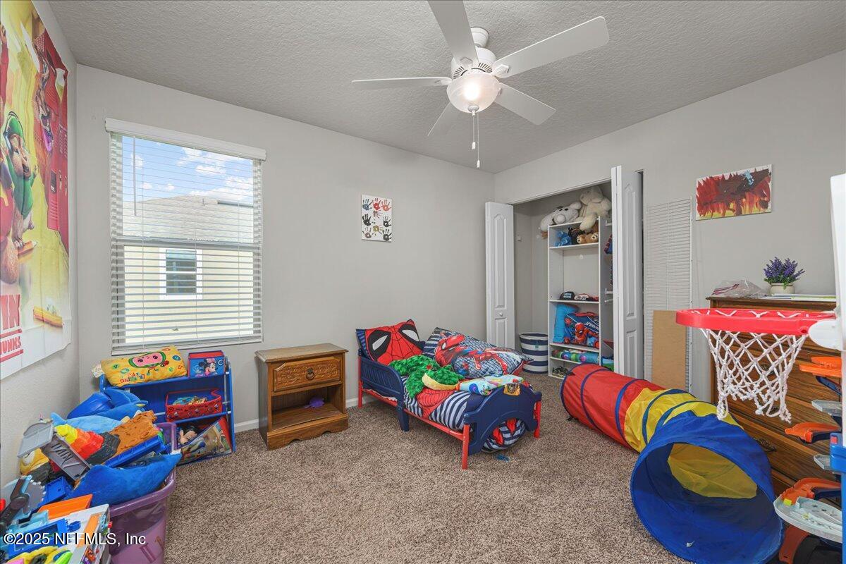 3557 Grayson Lane Middleburg, FL 32068 - Photo 10 of 18 a bedroom with toys and a couch