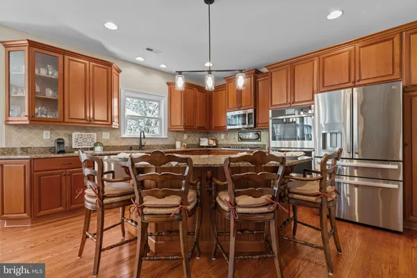 a kitchen with stainless steel appliances granite countertop a stove and cabinets