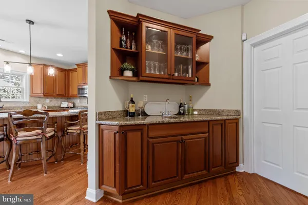 a view of a a dining room with furniture window and wooden floor