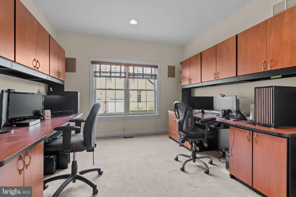 a spacious bedroom with a bed and a chandelier