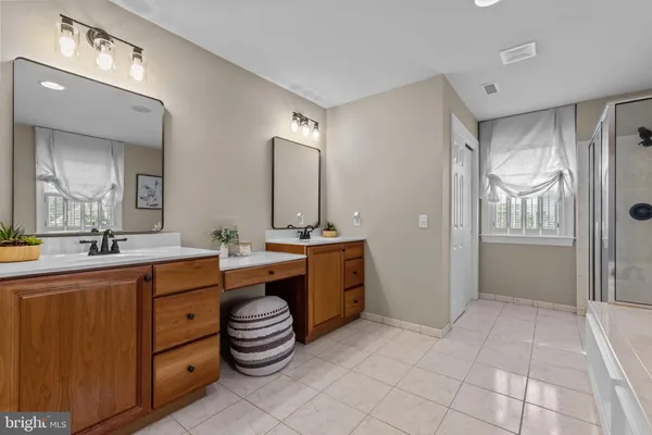 a bathroom with a granite countertop sink toilet and mirror