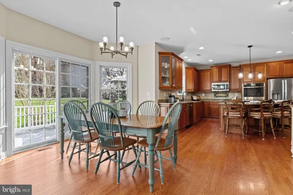 a kitchen with granite countertop wooden cabinets stainless steel appliances a sink and a window