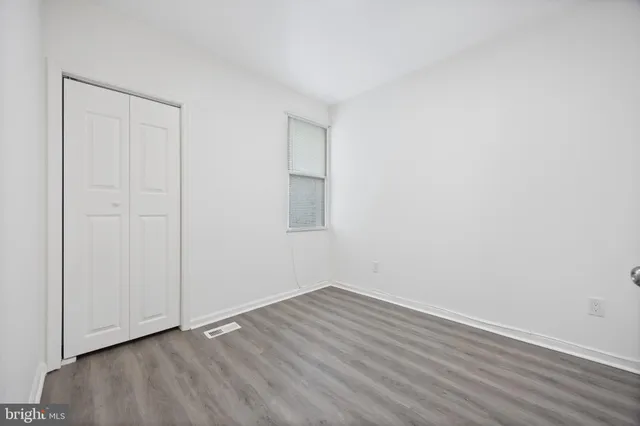 an empty room with wooden floor