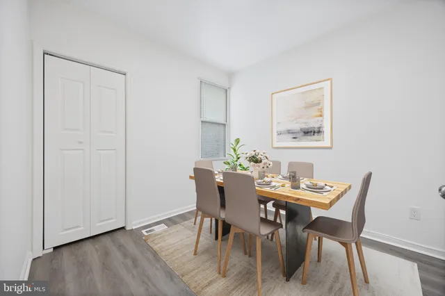 a dining room with furniture and wooden floor