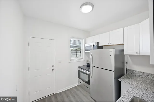 a white refrigerator freezer and a stove sitting inside of a kitchen