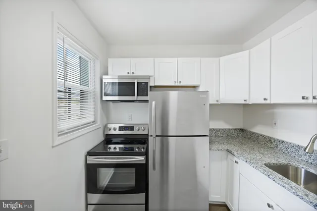 a kitchen with a refrigerator stove and microwave